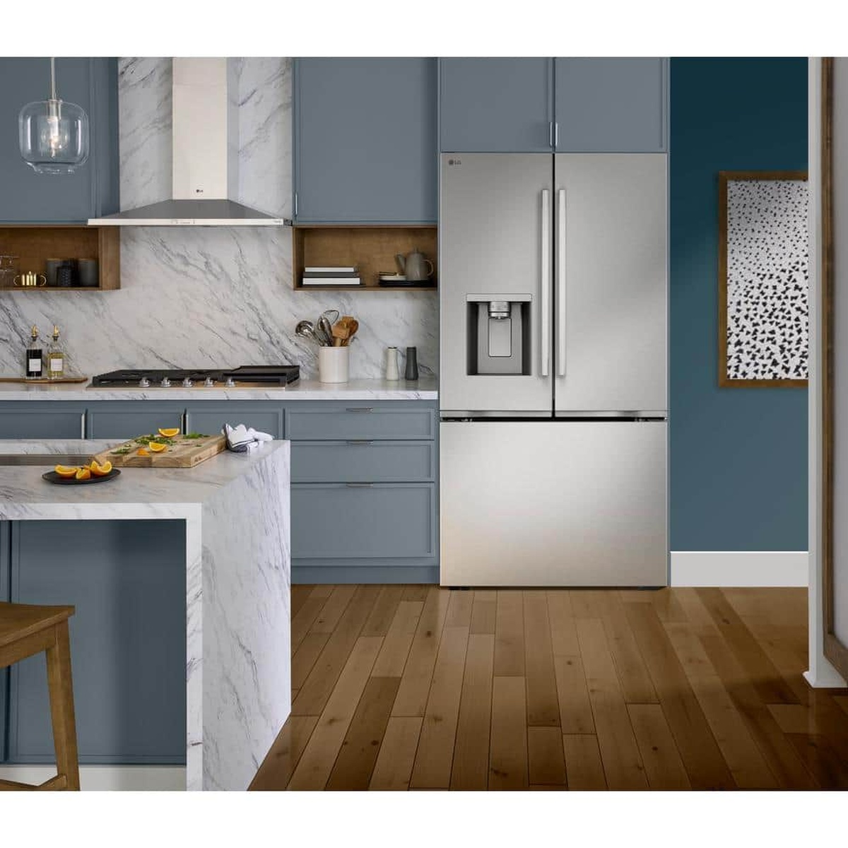 LG stainless steel French door refrigerator installed in a modern kitchen with cabinetry