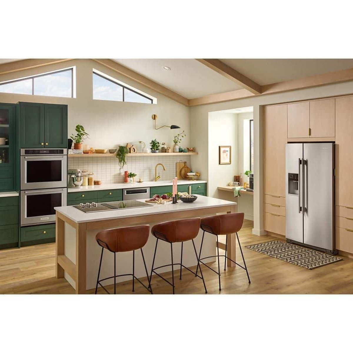 Kitchen lifestyle scene showing a stainless counter-depth side-by-side refrigerator installed with surrounding cabinetry