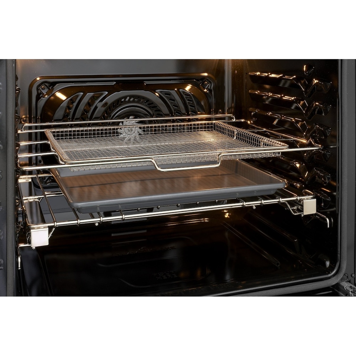Inside the oven showing the rear convection fan and an air fry tray on an oven rack