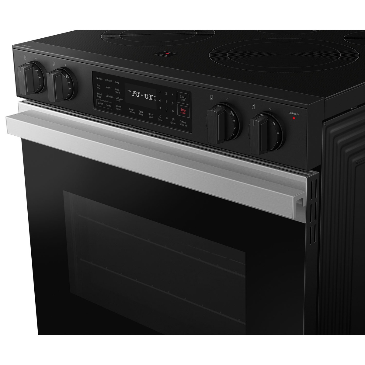 Angled close-up of the Samsung slide-in range showing the front control panel, knobs, and smooth cooktop surface.