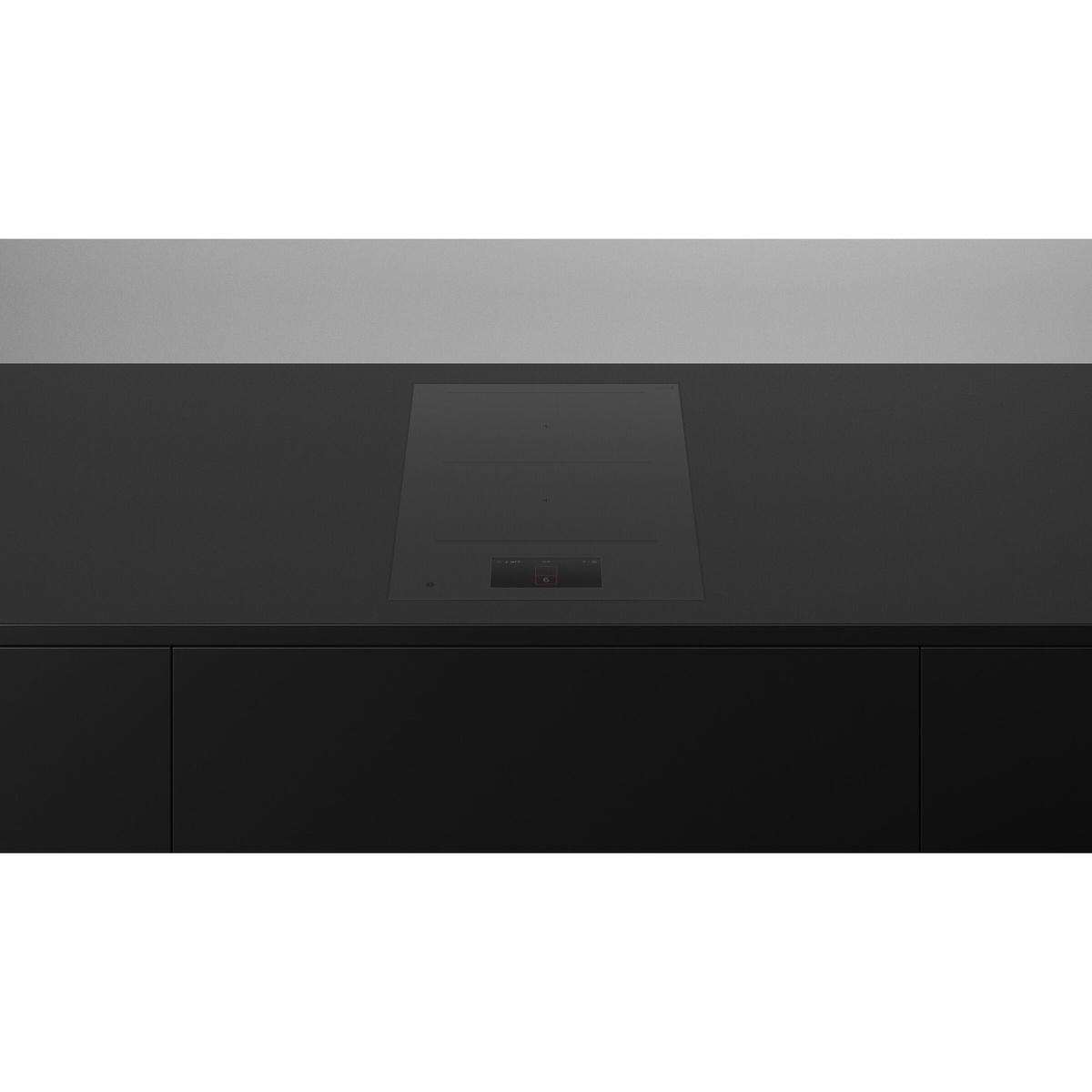Black glass induction cooktop installed flush into a dark countertop with a minimal control area