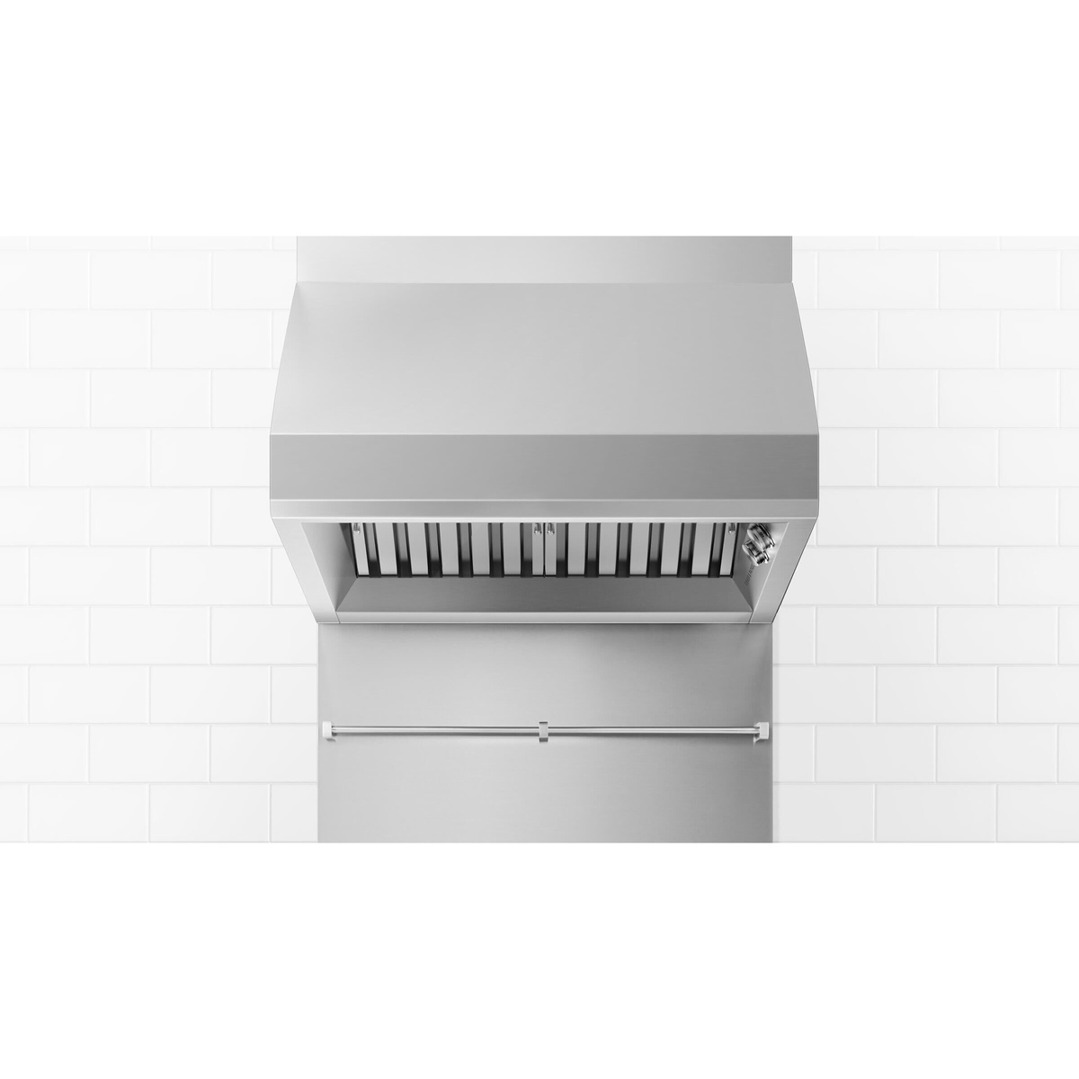 Stainless steel Fisher & Paykel wall range hood installed on a tiled wall above a matching backsplash