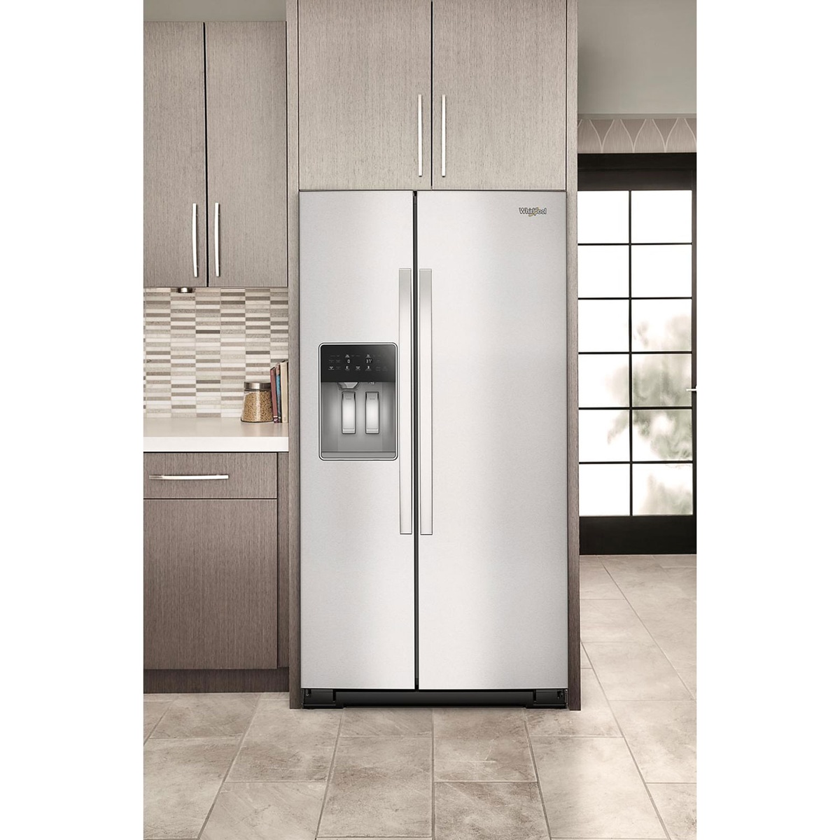 Whirlpool side-by-side refrigerator installed in a kitchen with surrounding cabinets