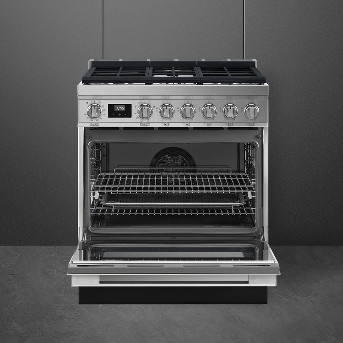 Smeg range with the oven door open showing the convection fan, multiple rack levels, and oven trays