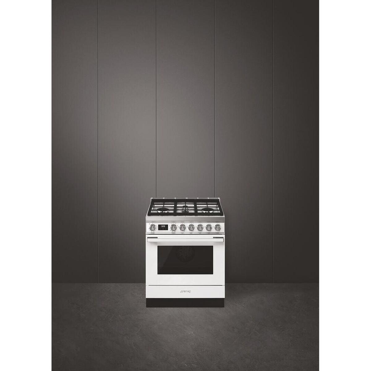 White Smeg freestanding range photographed in a minimal room setting