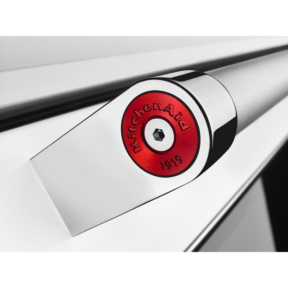Close-up of the KitchenAid handle endcap showing the red KitchenAid medallion