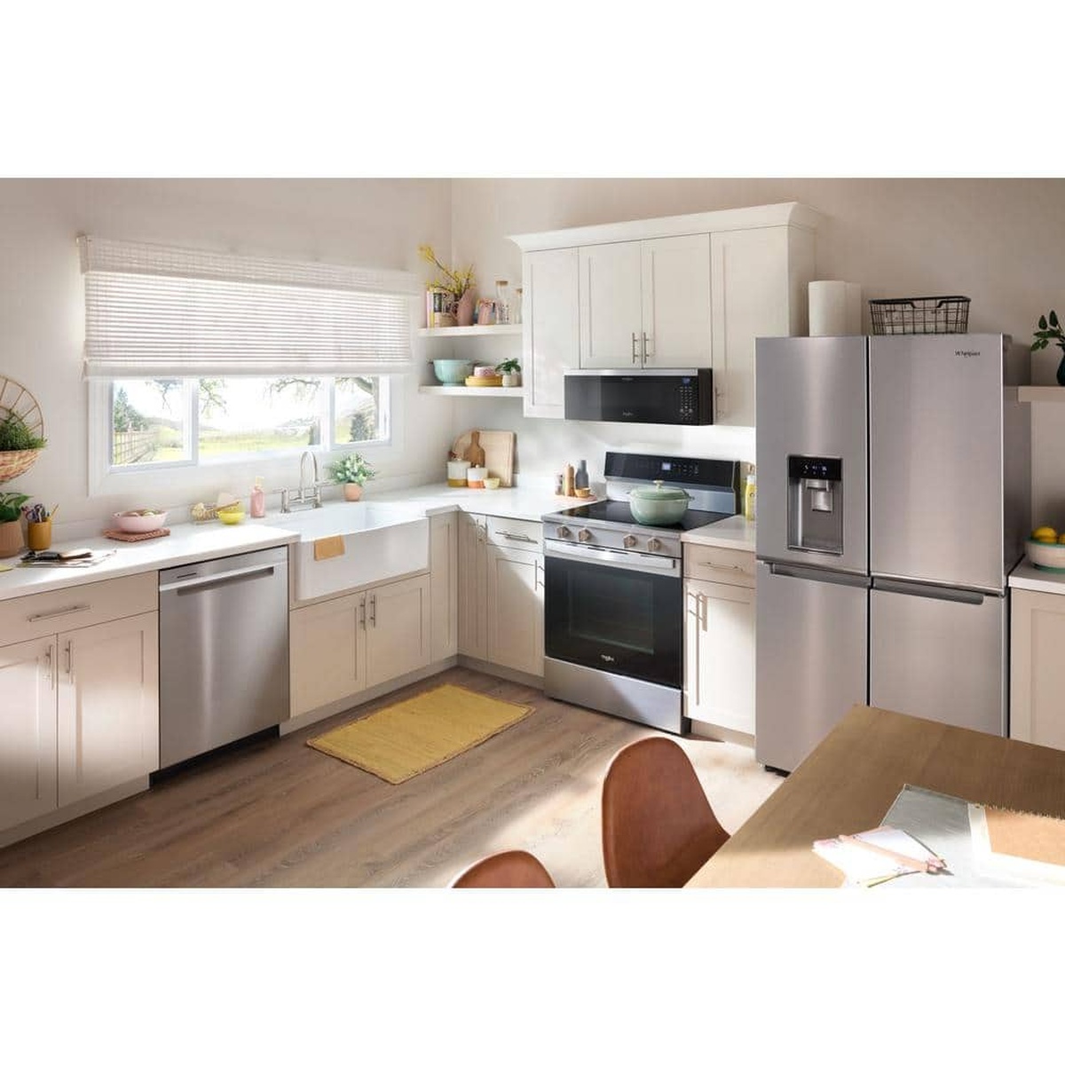 Bright kitchen scene with a stainless built-in dishwasher installed among matching appliances