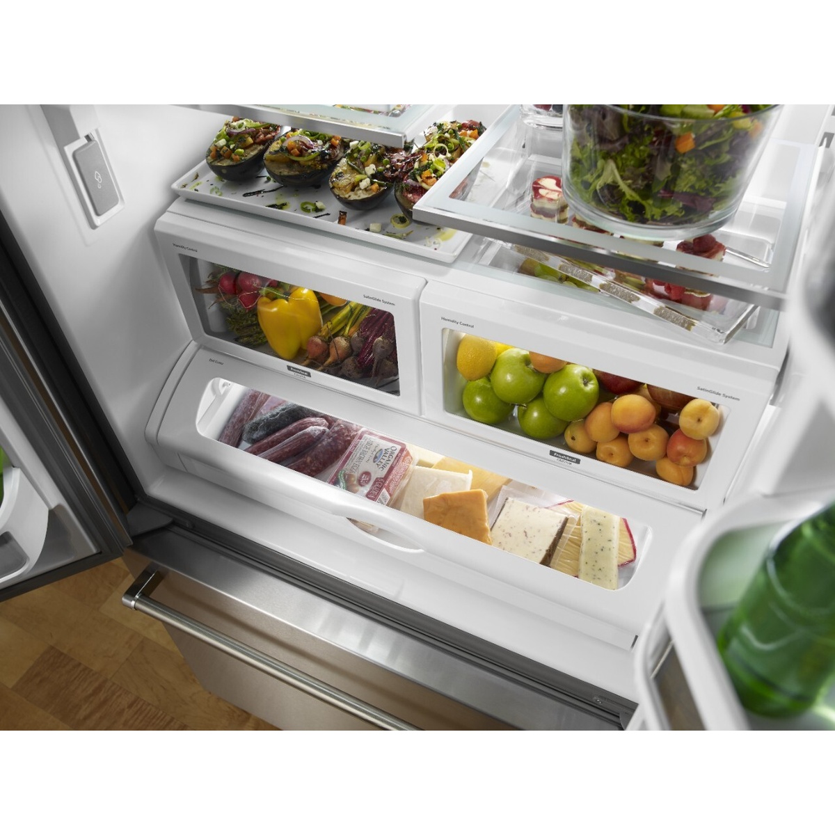 Close-up of the refrigerator interior showing two produce crispers and a full-width pantry drawer