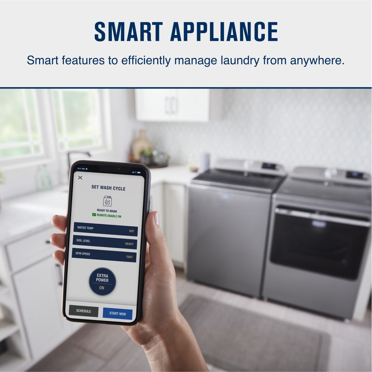 Hand holding a smartphone showing a laundry control screen, with a Maytag laundry pair in the background and text reading Smart Appliance