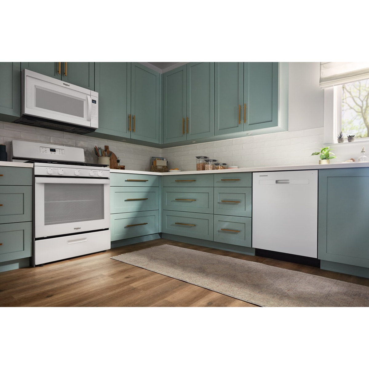 White Whirlpool built-in dishwasher installed in a kitchen with teal cabinets