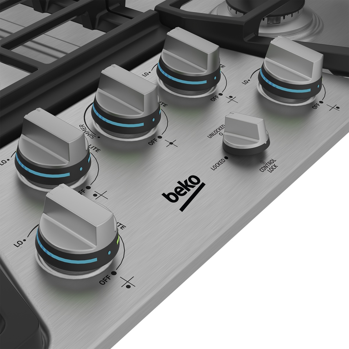 Close-up of illuminated control knobs and control lock on stainless cooktop