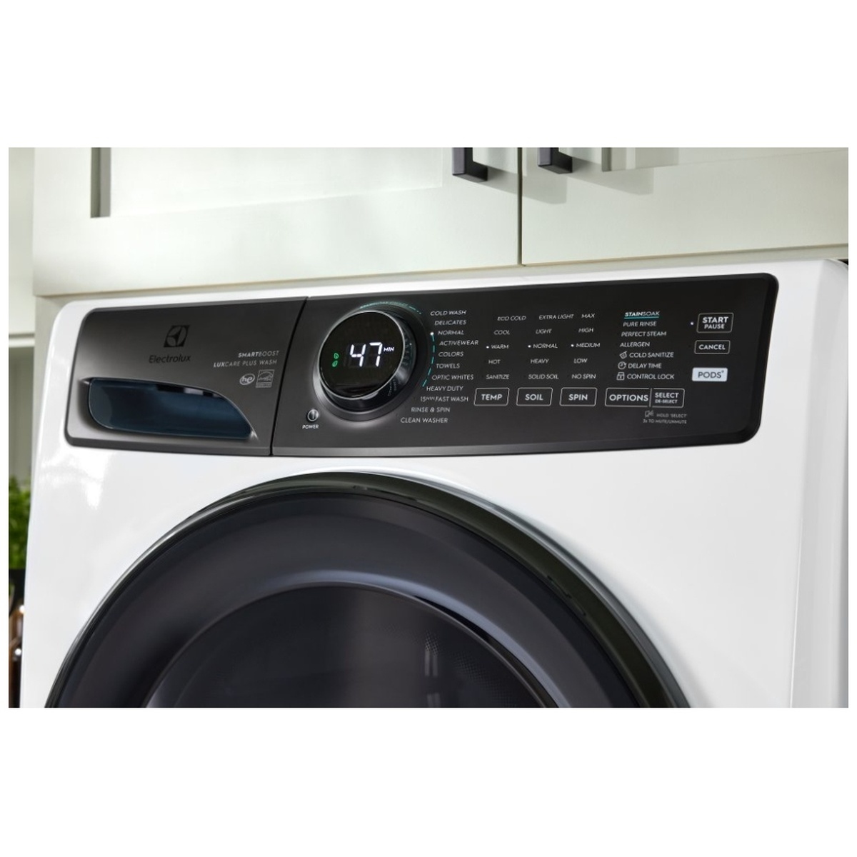 Electrolux front load washer installed under cabinets with the control panel visible
