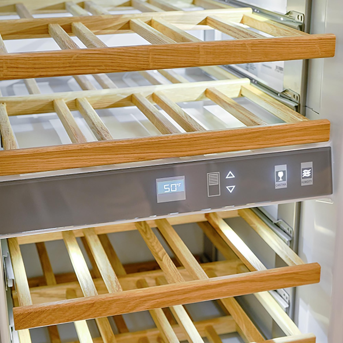 Close-up of beechwood wine racks with digital temperature readout and touch controls