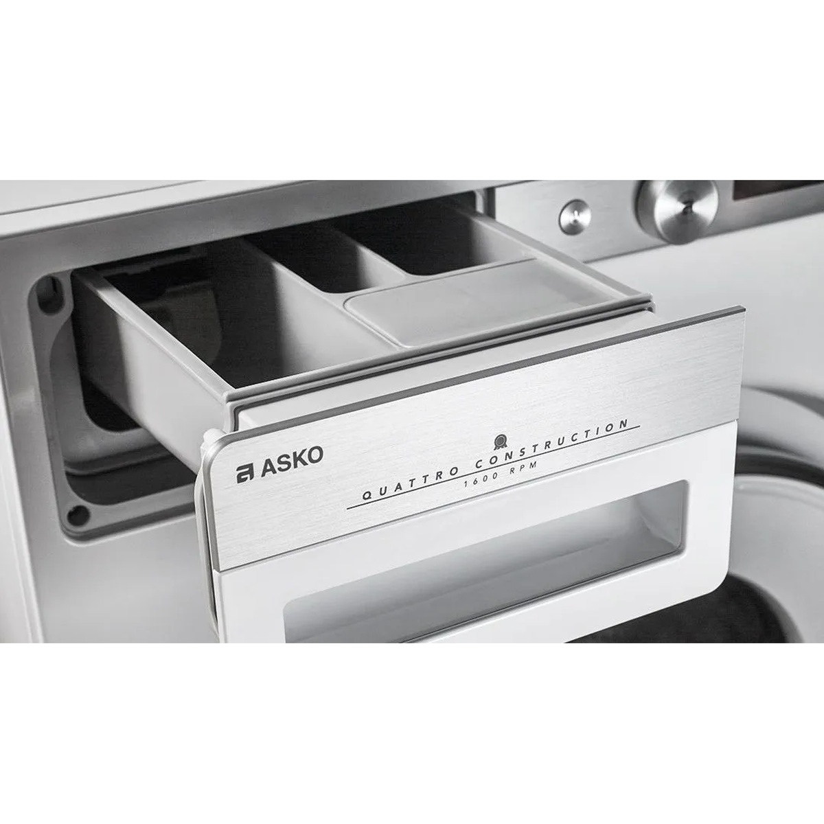 Detergent drawer pulled open showing multiple compartments