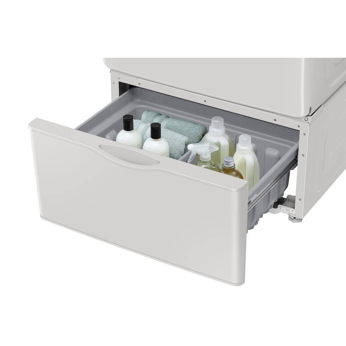 Ivory Samsung laundry pedestal drawer pulled open beneath a front-load machine, holding bottles and folded towels