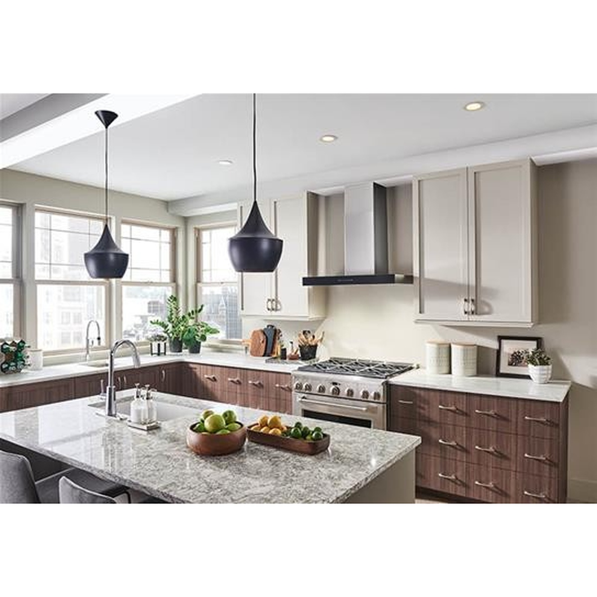 Modern kitchen with a wall-mount chimney range hood installed above a cooking surface.