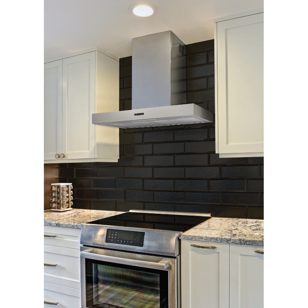 Stainless steel wall-mount chimney range hood installed in a modern kitchen above a range