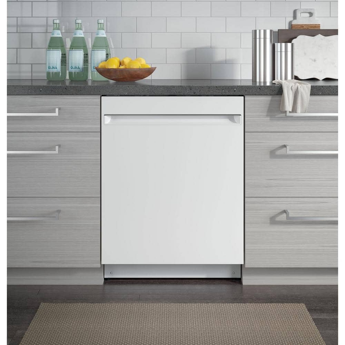 White built-in dishwasher installed under a kitchen counter between cabinets