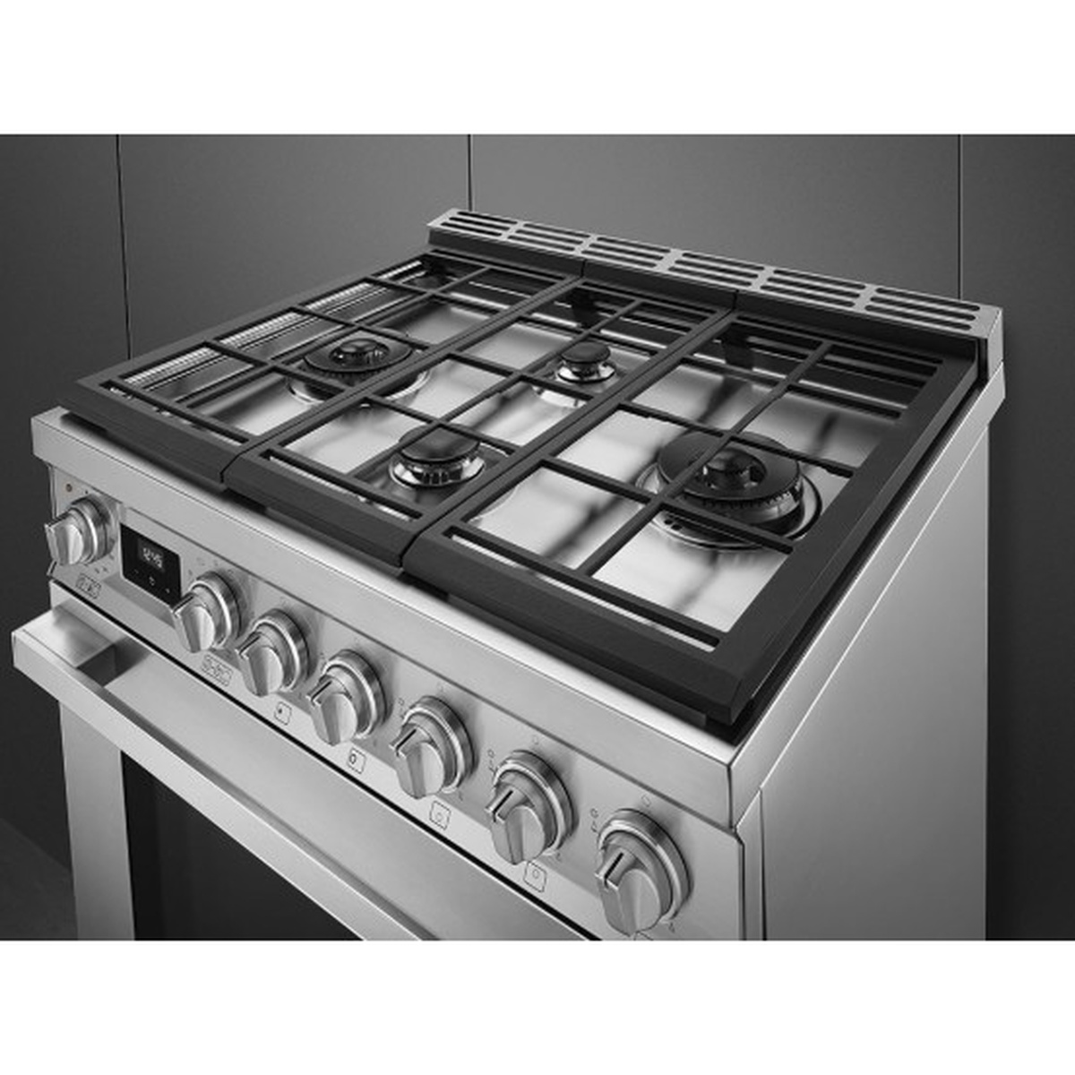 Close-up of the range cooktop with cast-iron grates and five gas burners