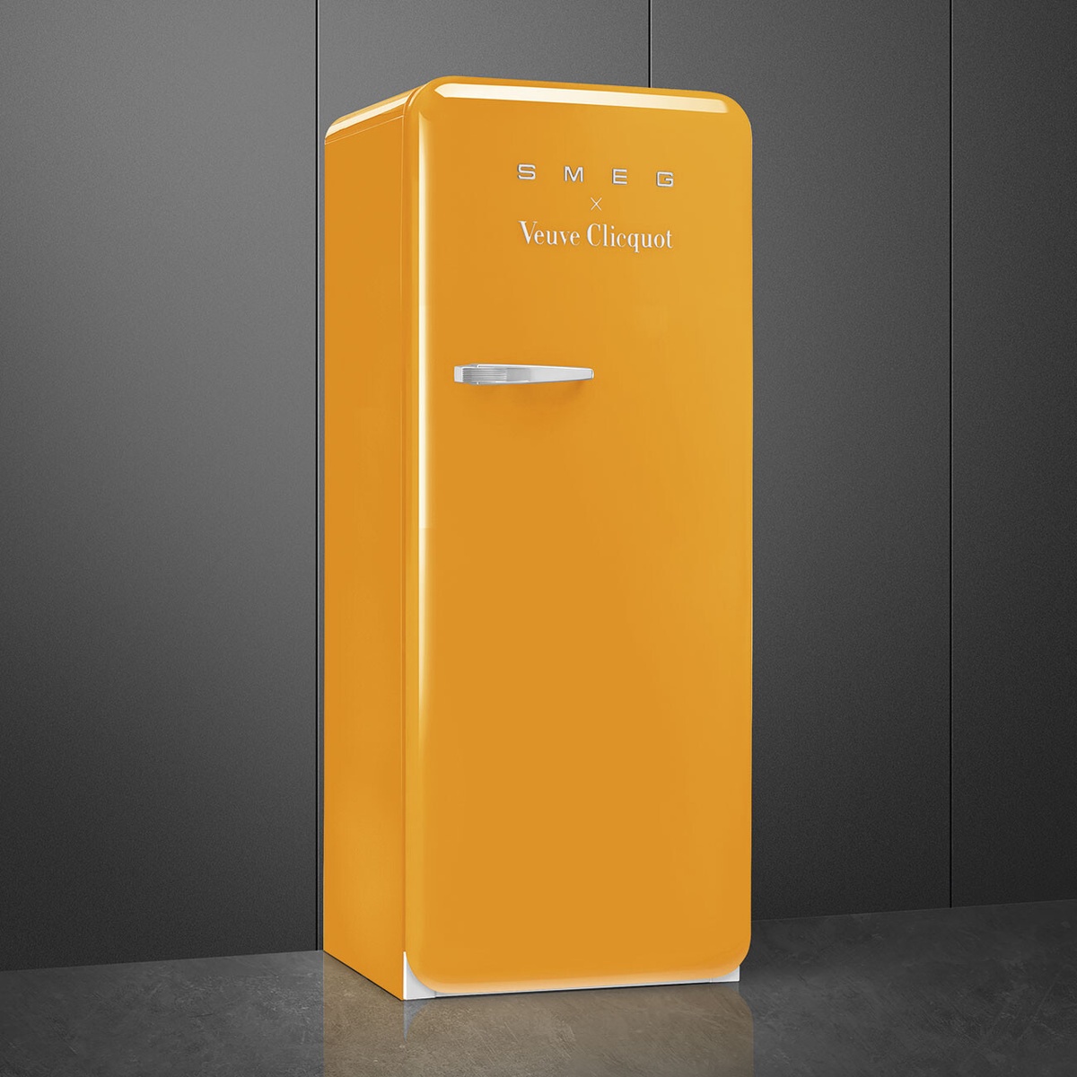 Smeg x Veuve Clicquot glossy yellow retro-style refrigerator with chrome handle in a modern kitchen setting