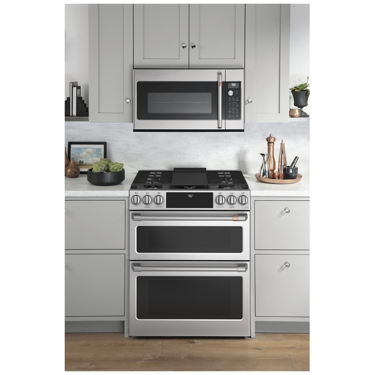 Café stainless steel double-oven range installed in a kitchen, showing the front controls and cooktop
