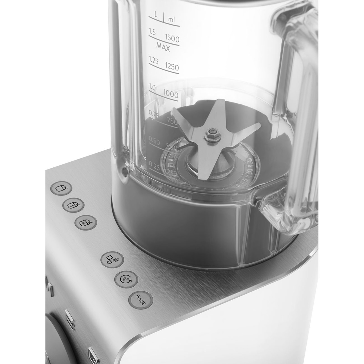 Close-up of the blender jug showing measurement markings, stainless steel blade assembly, and top preset buttons including a Pulse button
