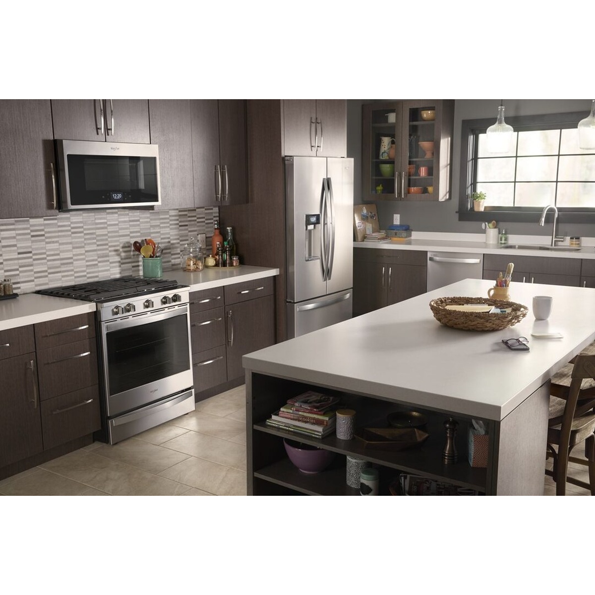 Modern kitchen with a Whirlpool slide-in stainless steel range installed under a microwave
