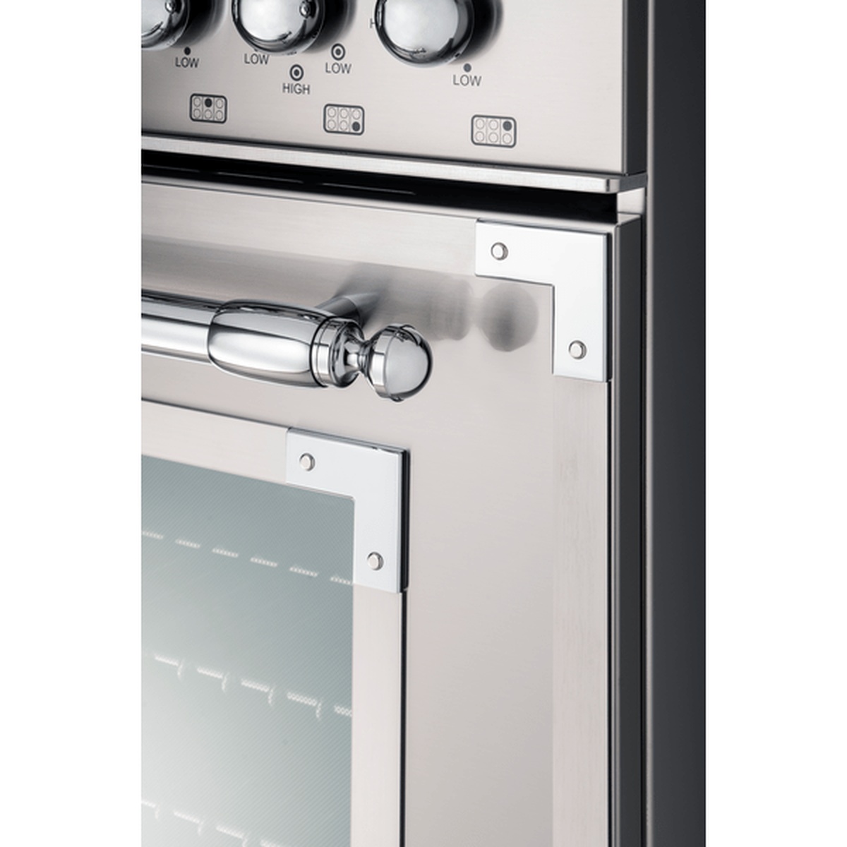 Close-up of the Bertazzoni Heritage range front showing metal control knobs and the oven door handle in stainless steel