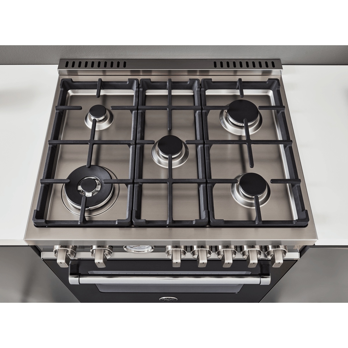 Top-down view of a stainless steel Bertazzoni range cooktop with five gas burners and continuous cast-iron grates