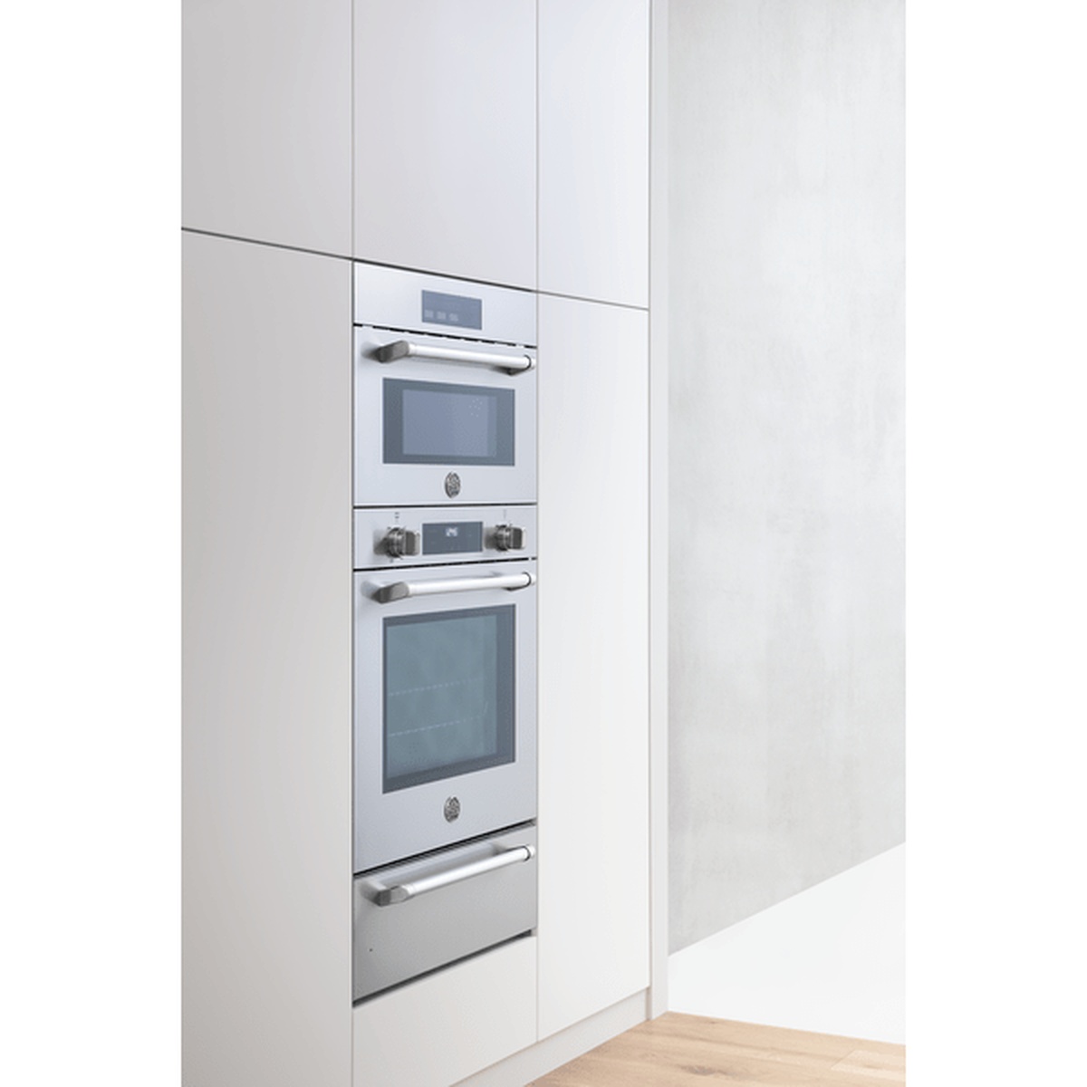 Bertazzoni built-in oven stack installed in tall white cabinetry showing a coordinated suite look