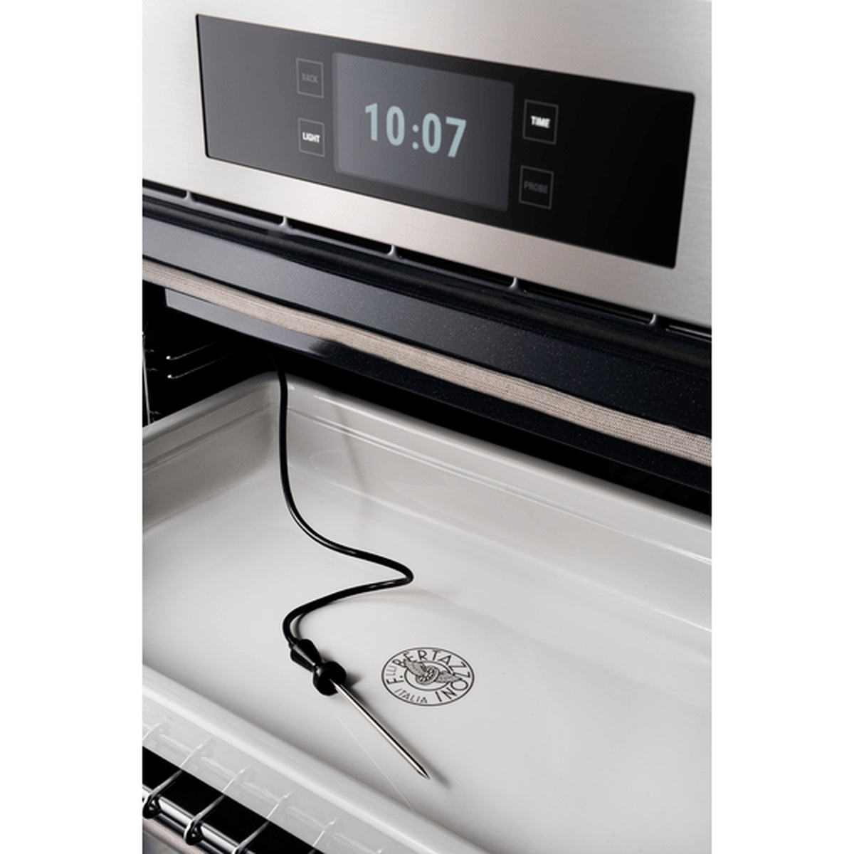 Close-up of the oven TFT touch display with control buttons and a temperature probe inside the oven cavity