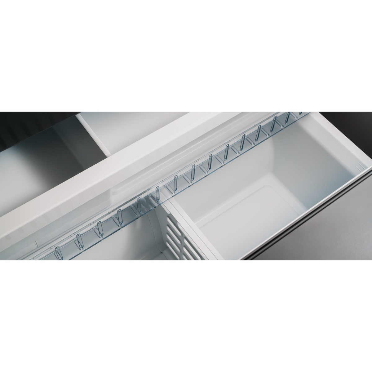 Close-up of the refrigerator’s bottom freezer drawer showing a bin-and-drawer organization layout