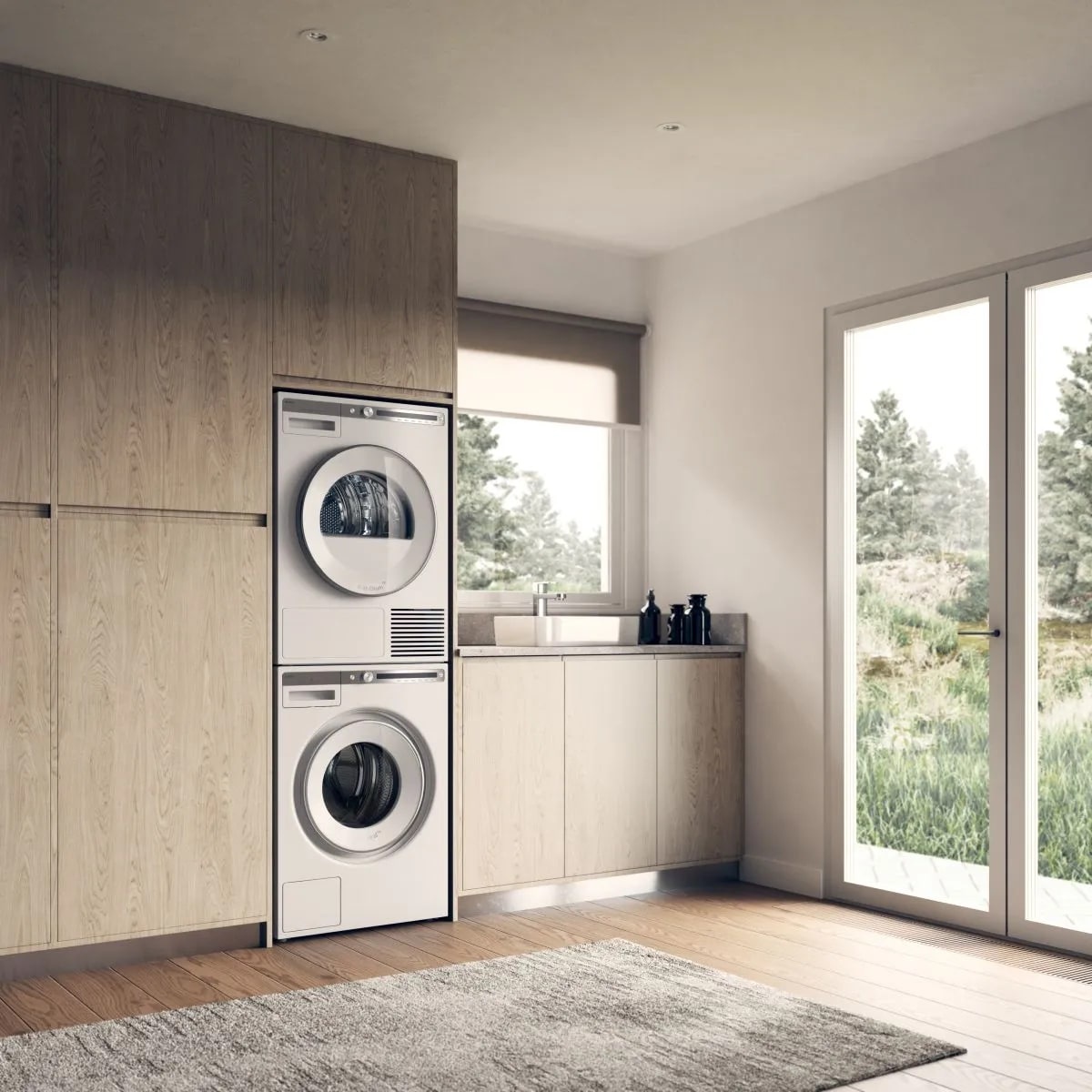 Built-in laundry room showing a stacked ASKO washer and dryer installed within tall wood cabinetry next to a countertop and sink