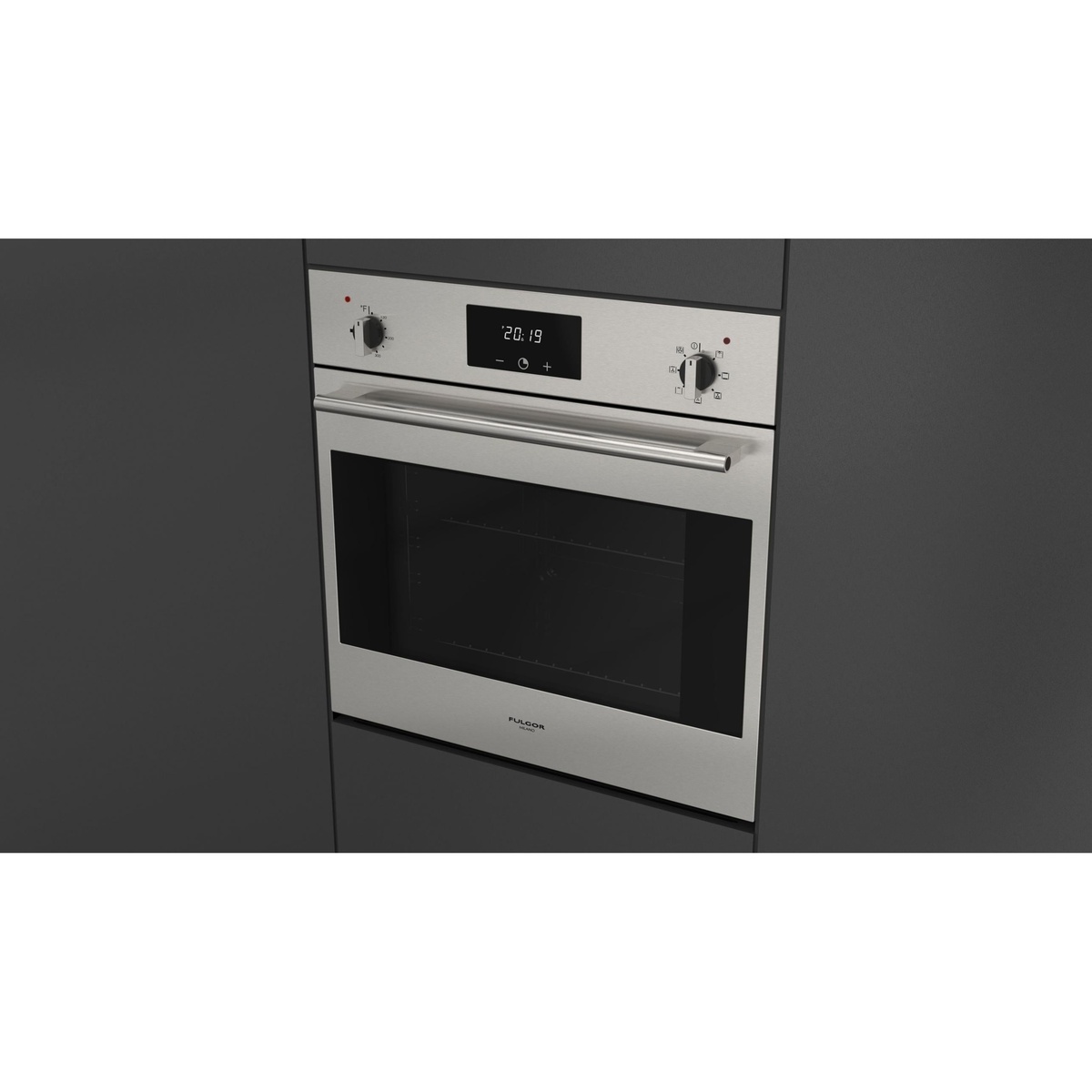 Angled view of a stainless steel built-in wall oven installed in dark cabinetry, showing the handle and control panel