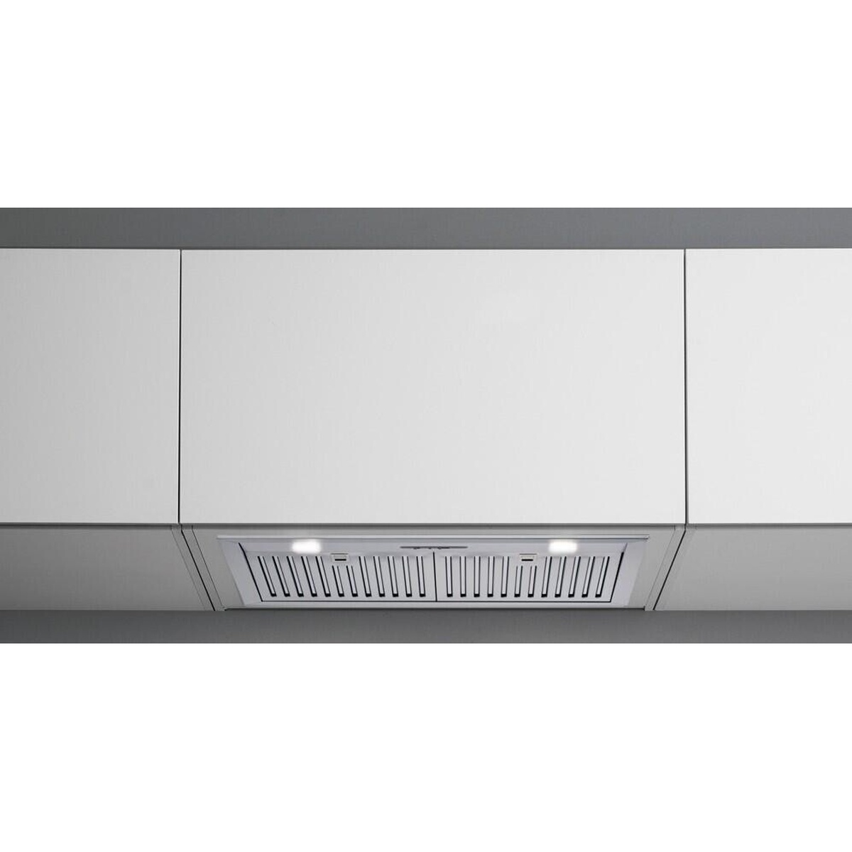 Installed view of the Falmec cabinet insert hood under a kitchen cabinet with the lights turned on