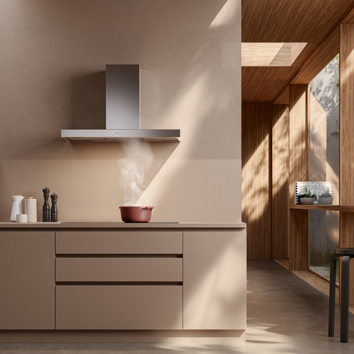 Modern kitchen scene with a stainless steel wall-mounted range hood above a cooktop with steam rising from a pot
