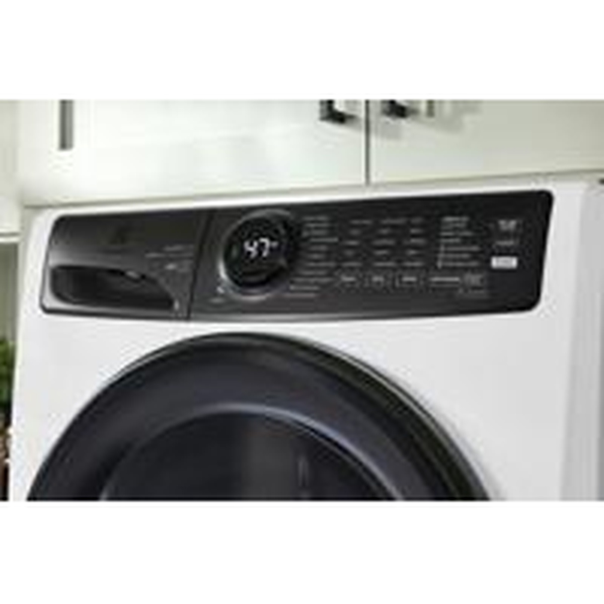 Electrolux front load washer installed in a home laundry space under cabinetry