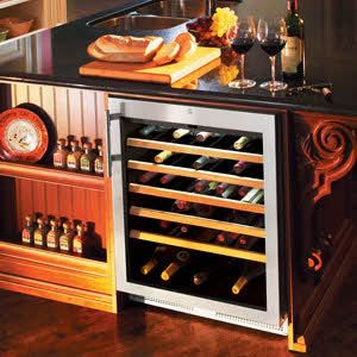 Liebherr HWS1800 wine cabinet installed in a kitchen island with bottles displayed on wooden shelves in an elegant entertaining setting