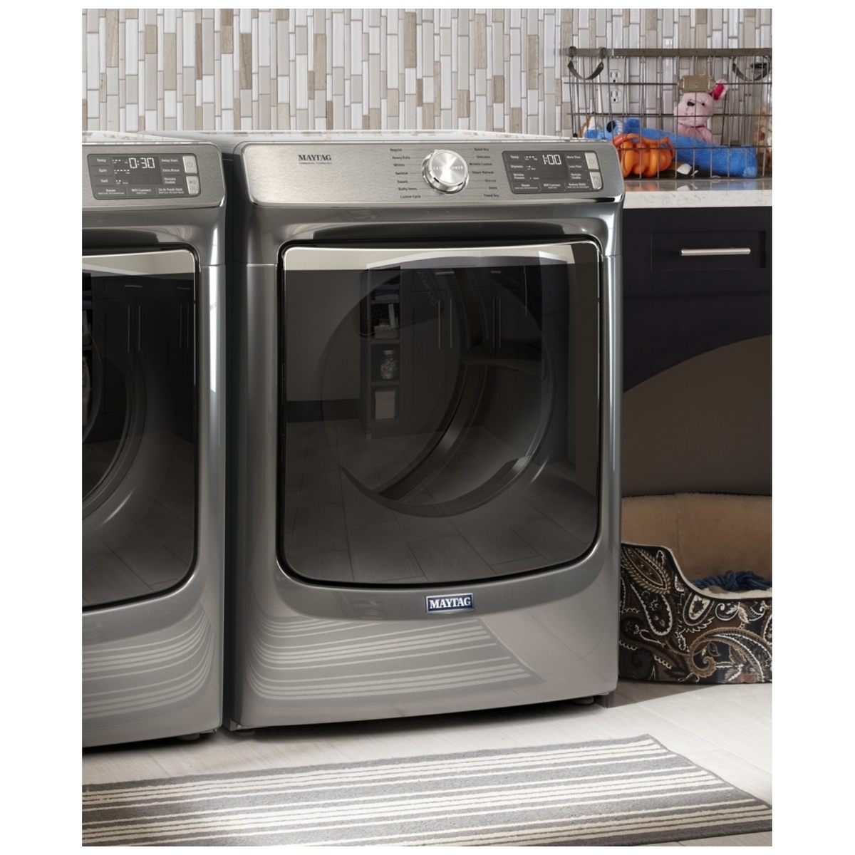 Maytag front-load laundry set installed in a home laundry room with a matching washer and dryer in Metallic Slate