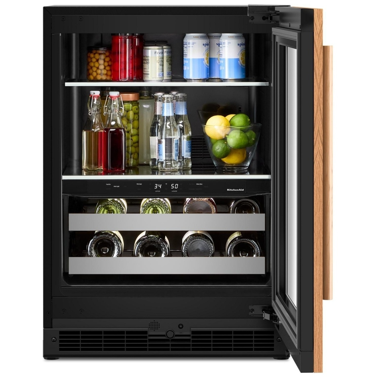KitchenAid KUBR524SPA beverage center door open showing upper shelves stocked with canned beverages, bottled drinks, and fresh produce alongside lower wine racks holding multiple bottles