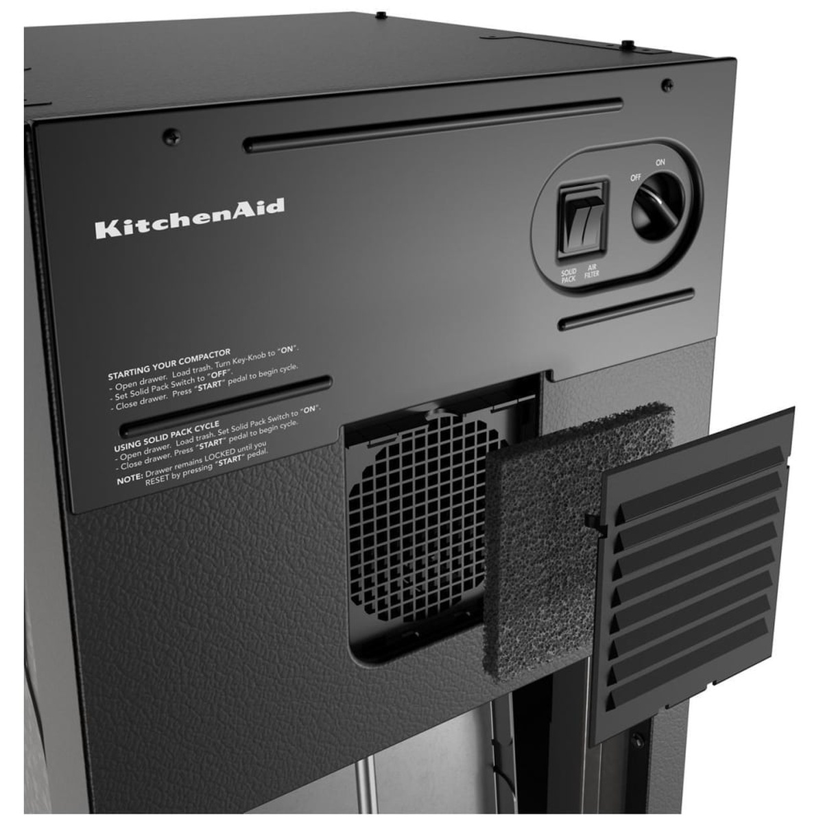 Close-up of the KitchenAid KTTP515TSS rear control panel showing the solid pack toggle, air filter fan switch, and the charcoal filter odor management system with ventilation housing open