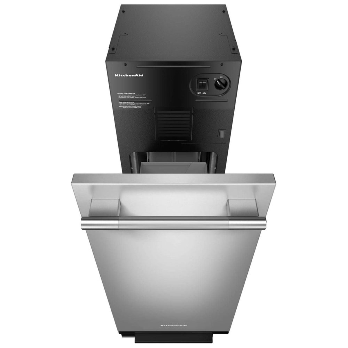 KitchenAid KTTP515TSS trash compactor viewed from above with door open, revealing the stainless steel interior drawer, bag retainer buttons, and top-mounted dial and toggle controls