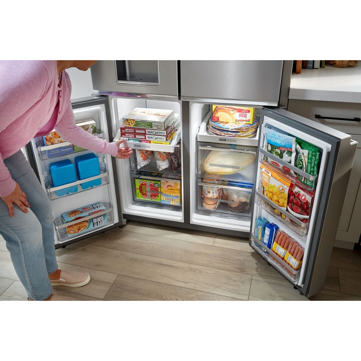 Both lower freezer doors of the Whirlpool WRQC7836RZ open wide, showing Easy Access pull-out shelving, loaded door bins, and organized frozen food storage