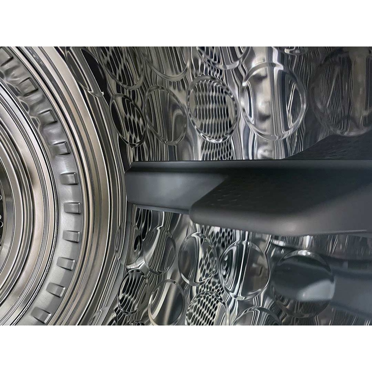 Close-up view of the stainless steel drum interior of the ASKO T611VU.W tumble dryer