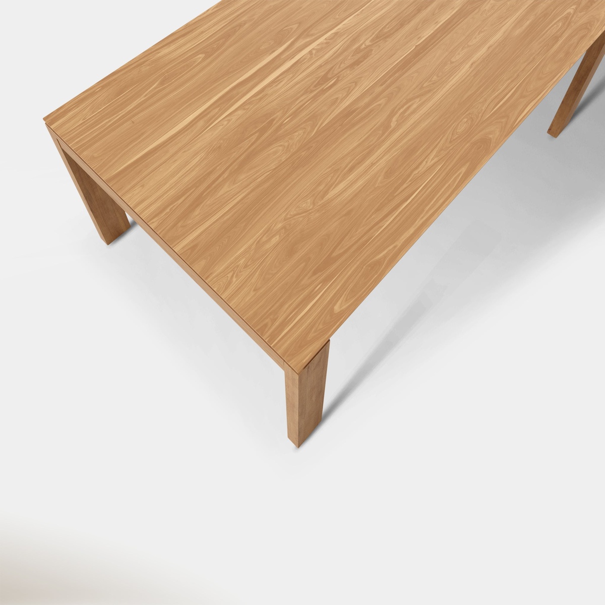 Overhead close-up of the Keaton Oak dining table surface showing rich natural wood grain and veneer detail