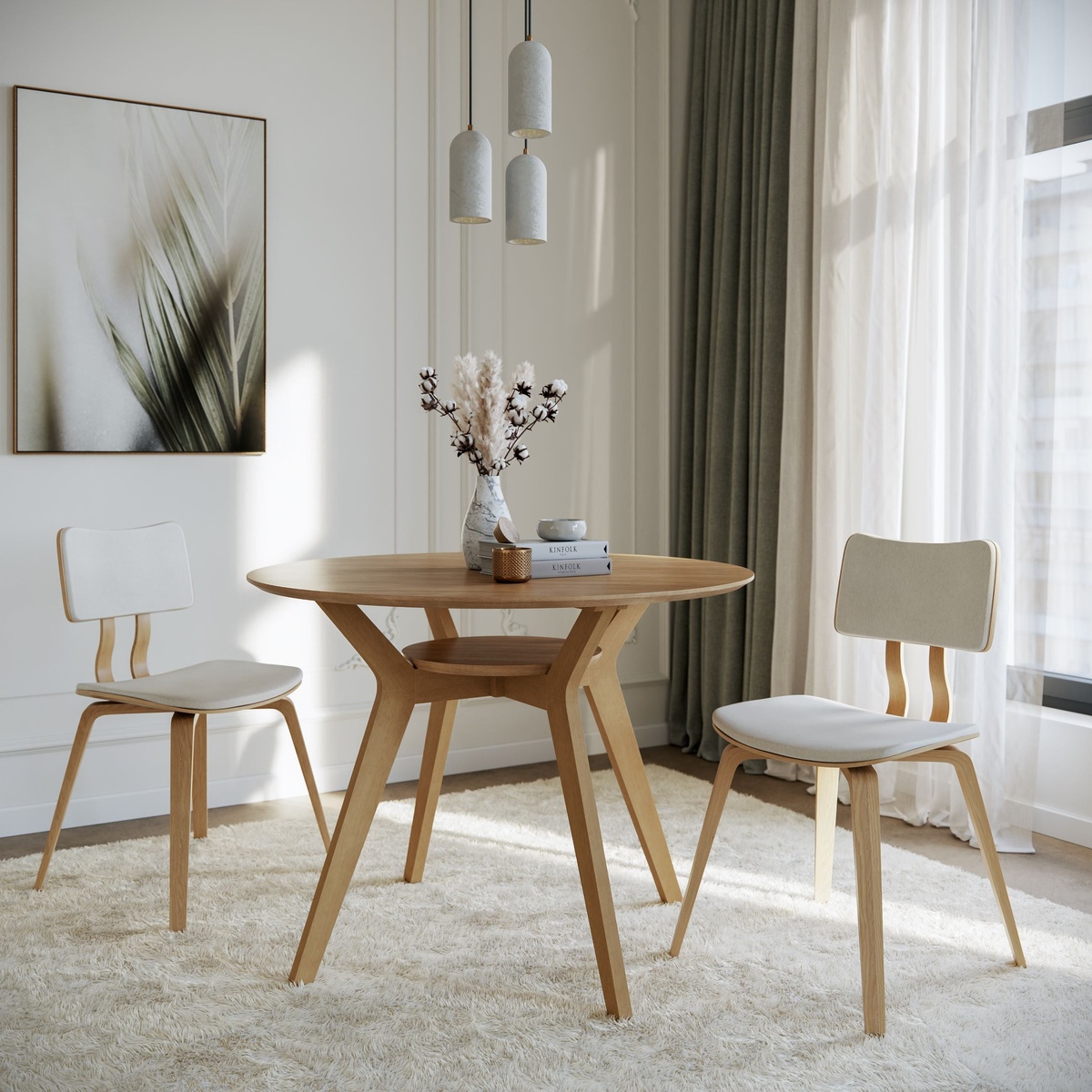 Ansel Dining Table in Oak styled in a bright white dining room with two upholstered chairs, a plush rug, pendant lighting, and decorative botanicals on the tabletop