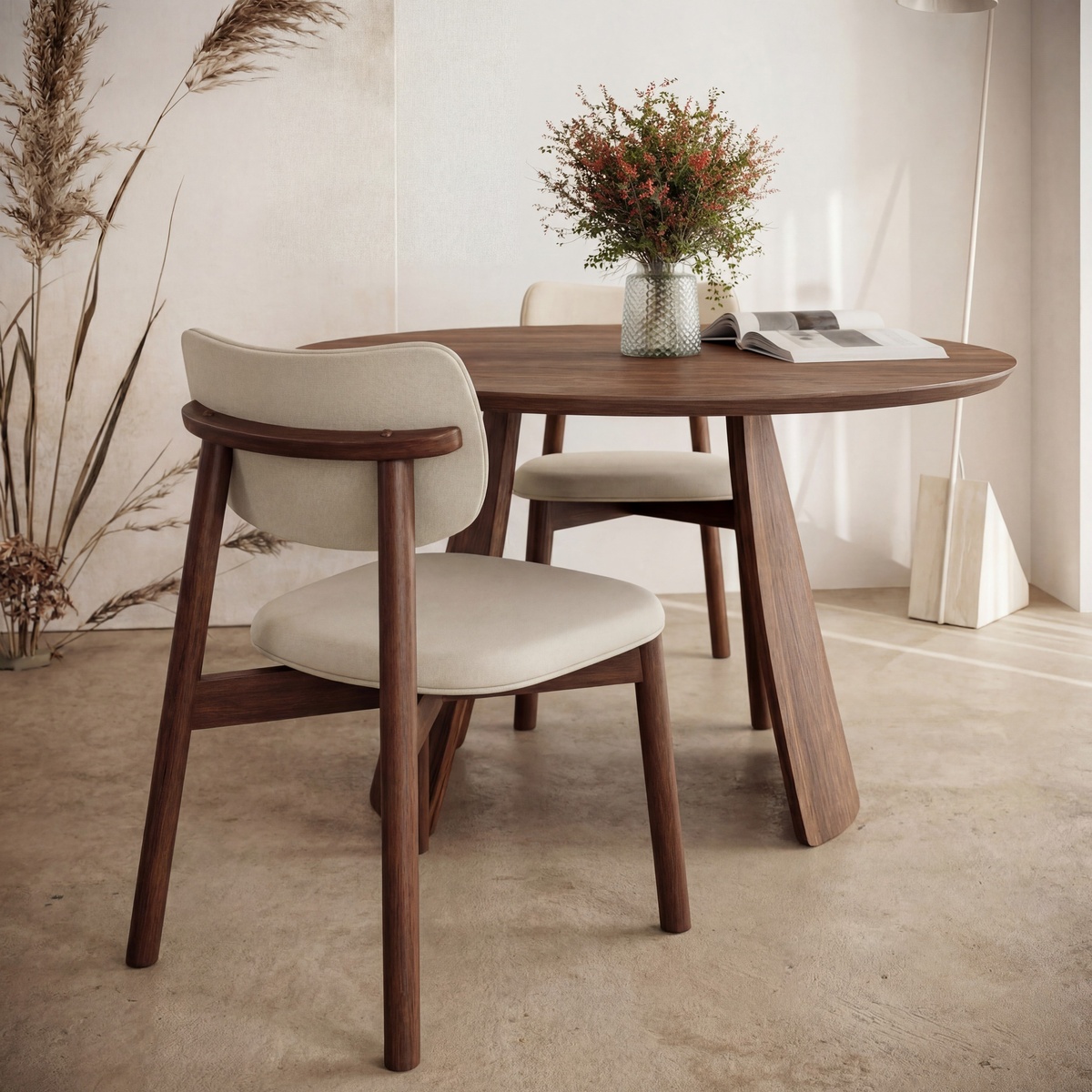 Obelia Walnut dining table styled in a warm Scandinavian-inspired dining space with upholstered chairs and dried botanical decor