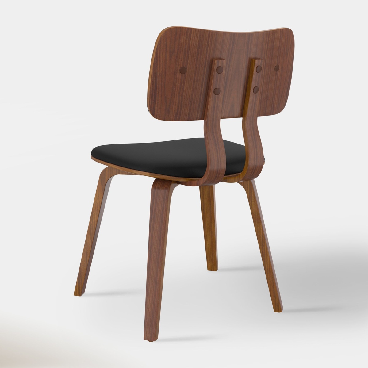 Rear three-quarter view of the Zaki dining chair showing the sculpted walnut bentwood back panel and black upholstered seat