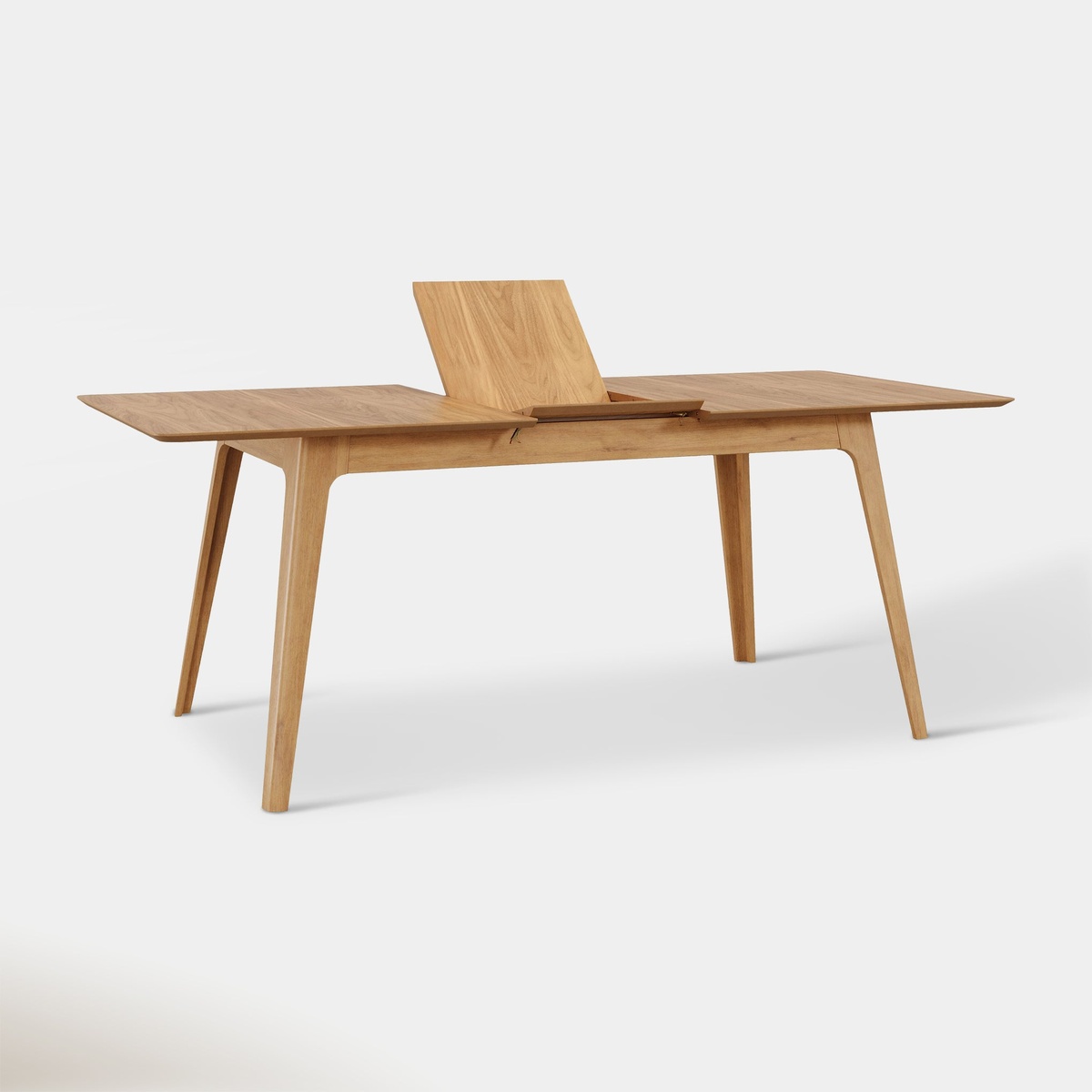 Venn Extendable Dining Table in Oak with butterfly leaf raised mid-extension, studio shot on white background