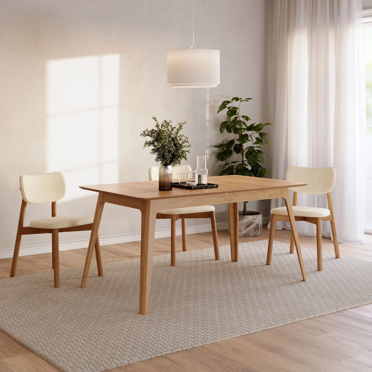 Venn Oak Dining Table styled in a bright natural dining room with cream upholstered chairs, a pendant light, and indoor plants